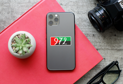 Autocollant code postal "972" avec drapeau régional, produit en papier par Prodigi, affiché à côté d'un iPhone 11 Pro.