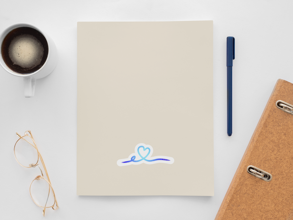Autocollant Coeur tracé Rose de Prodigi posé sur un carnet, illustration simple d'un cœur rose tracé.