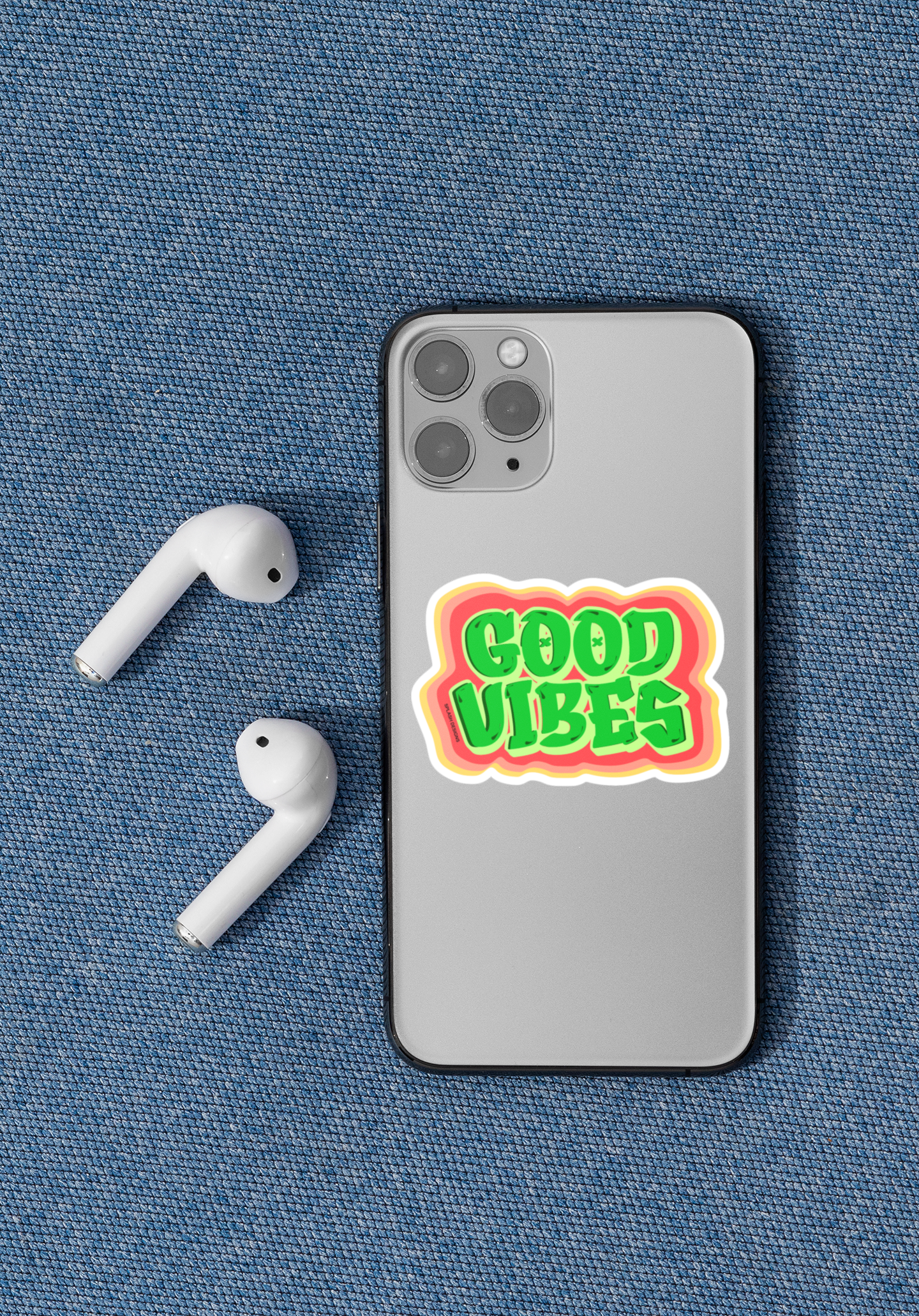 Autocollant "Good Vibes" de Prodigi appliqué sur un iPhone 11 Pro, affichant un design coloré et positif.